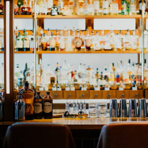 close up of shelves at a bar which are stocked with various spirits and liquours