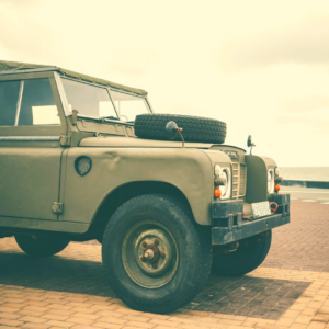 safari-style land rover parked by the ocean