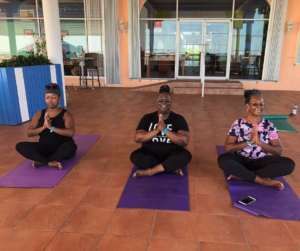 Women practicing yoga at Morritt's Resort in the Cayman Islands