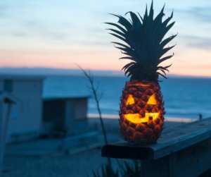 pineapple carved like a jackolantern for halloween