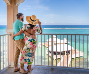 couple standing on the balcony overlooking the Caribbean sea at Morritt's Resort in the Cayman Islands