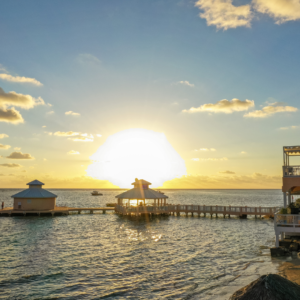 sun setting over Mimi's Dock Bar at Morritt's Resort in the Cayman Islands